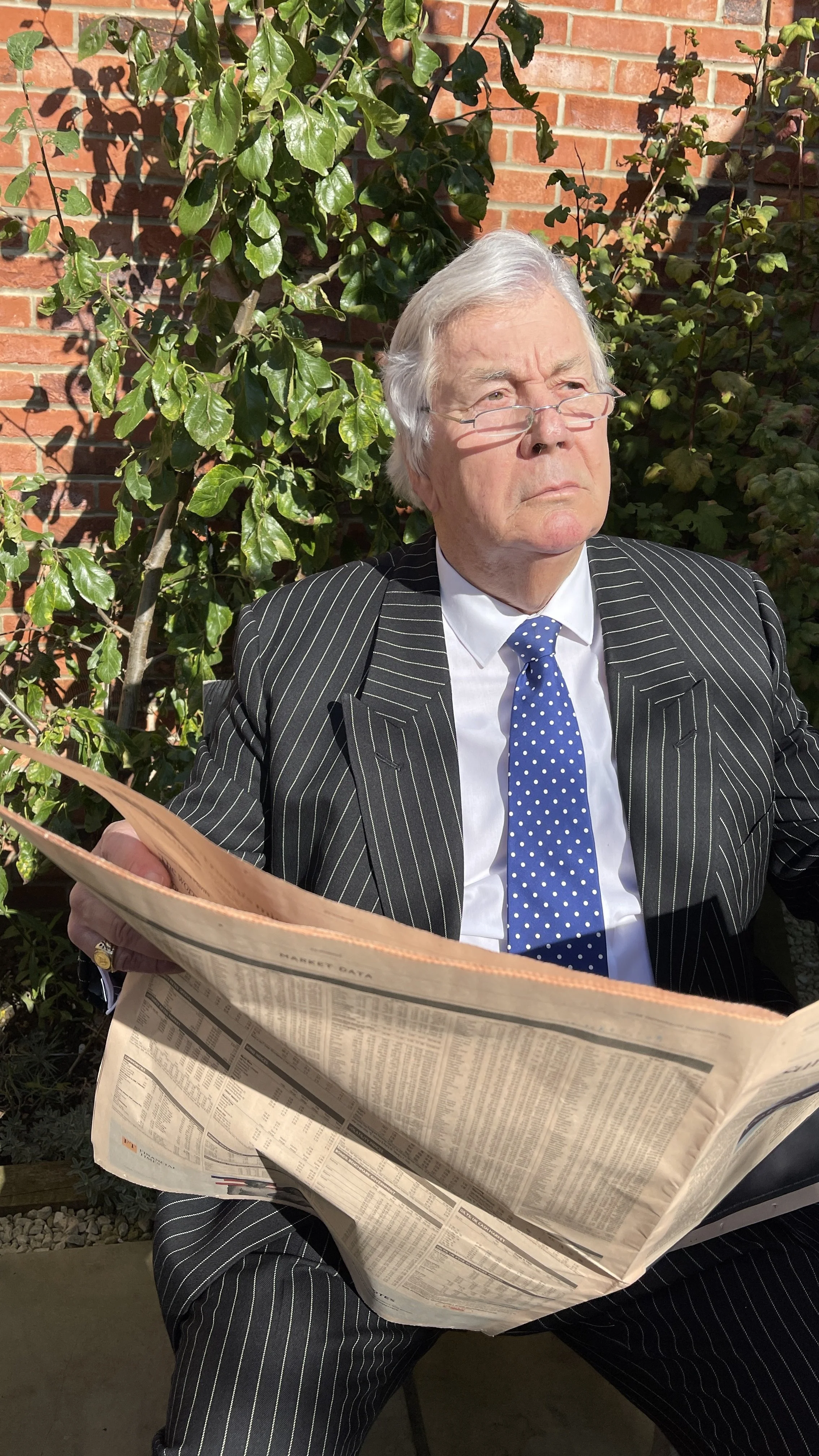 Portrait of Richard E. Ptardio reading the Financial Times